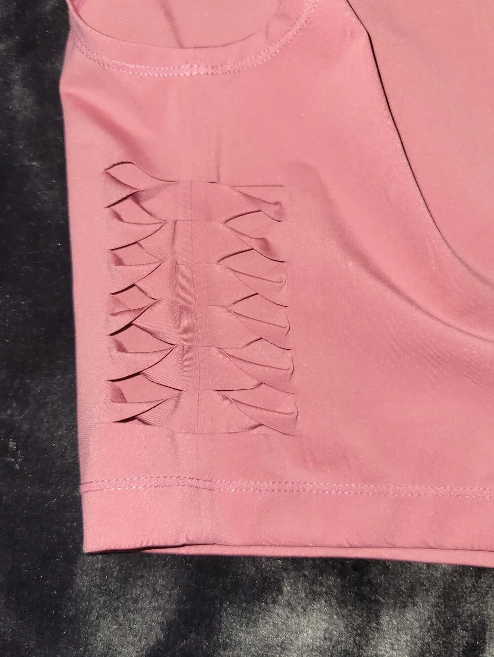 pink Nike Pro Dri-FIT crop top featuring distinctive side-cutout details